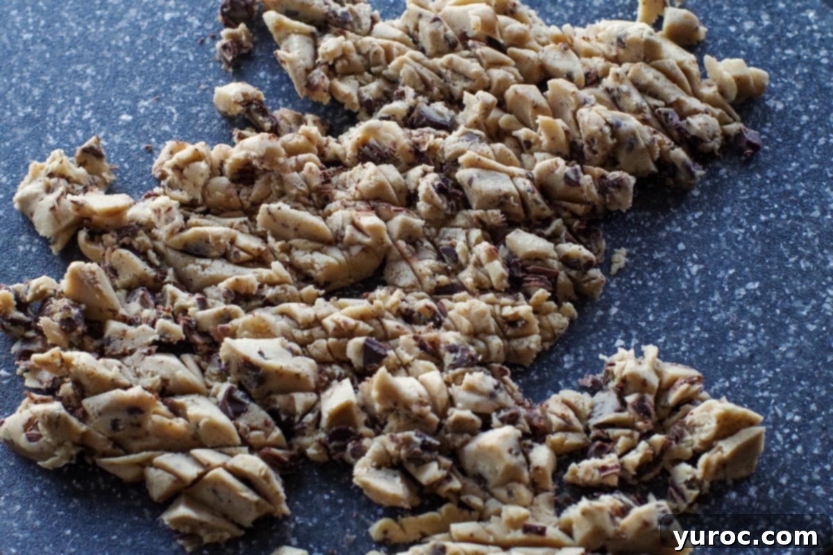 edible cookie dough chopped up on a cutting board
