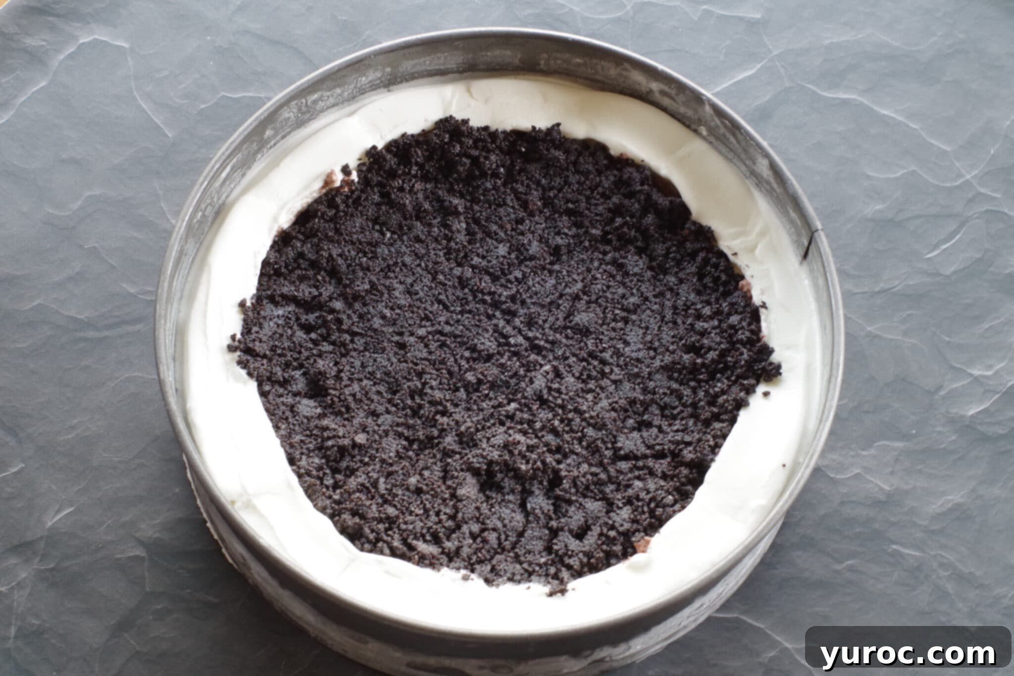 Oreo cookie crumbs mixture in middle of ice cream cake
