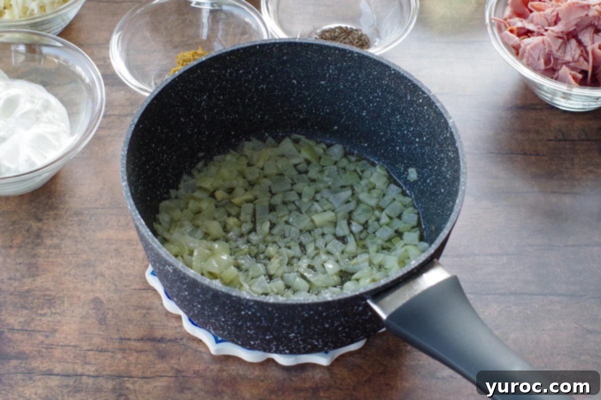 onions and butter cooked in a pot with ingredients in dishes in background