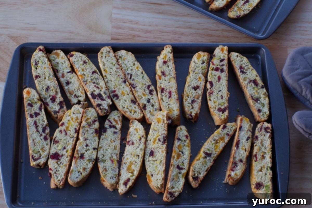 Pieces of biscotti, cut side down on a cookie sheet, ready for the second bake to achieve crispness.
