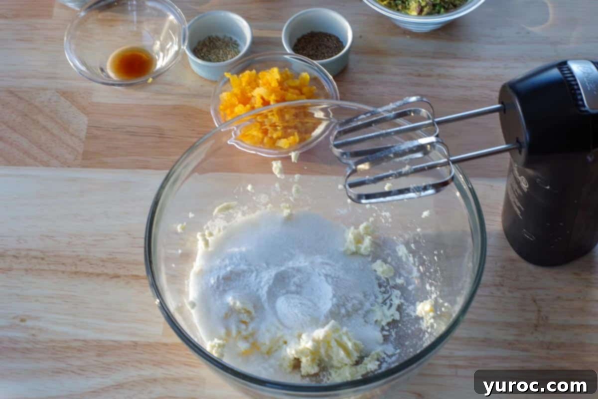Butter, sugar, baking soda and salt combined in a glass bowl, forming the base of the biscotti dough.