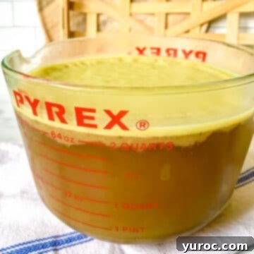 homemade ham stock in a giant glass measuring cup