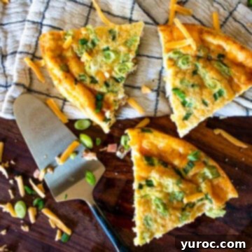 3 crustless quiche pieces on a checkered linen surface with pie lifter