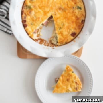 a piece of crustless ham and cheese quiche on a white plate and a whole quiche (with a piece missing) in the background