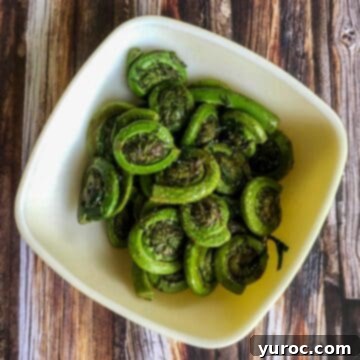 15 Creative Fiddlehead Dishes 19 Fiddleheads with lemon and butter in a white bowl