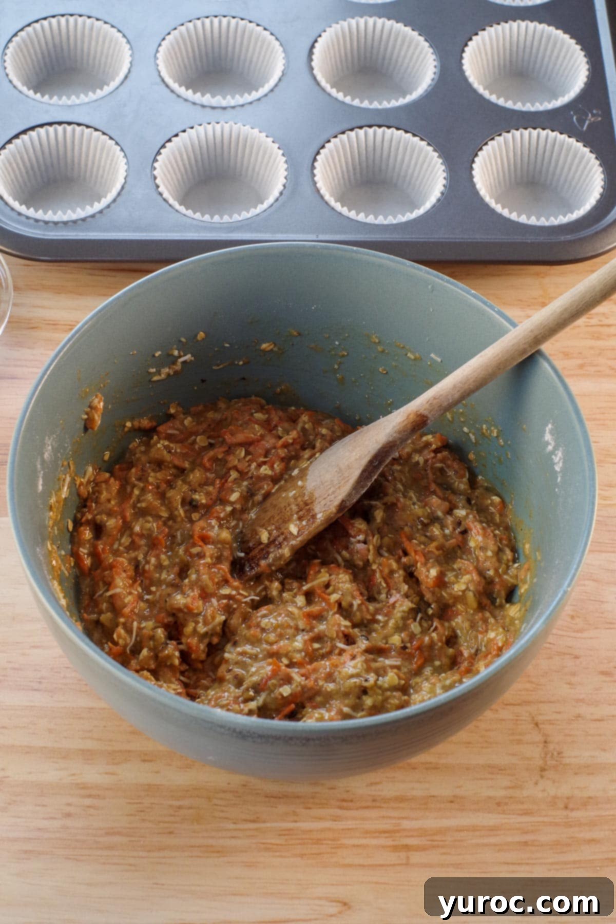muffin batter in blue bowl mixed together