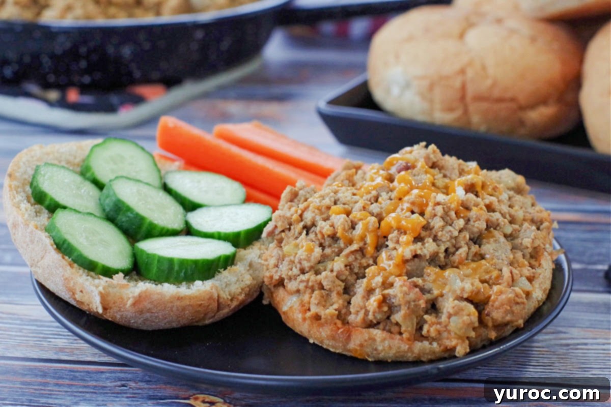 Guilt-Free Turkey Sloppy Joes 2 photo of weight watchers turkey sloppy joes on a black plate with carrots and cucumbers