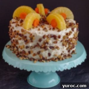 Guilt-Free Carrot Cake Delight 12 whole carrot cake decorated with pineapple and carrots on a aqua cake stand