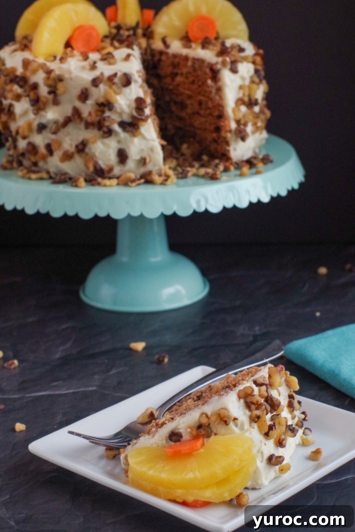 Guilt-Free Carrot Cake Delight 10 healthy and light carrot cake on a aqua cake stand in background with slice of cake on a white plate in front