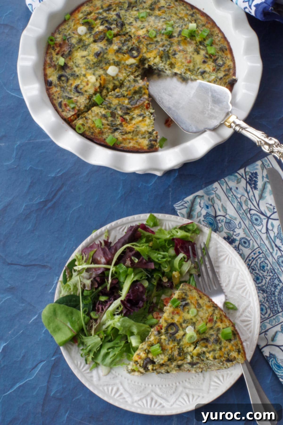 Mediterranean Slim Crustless Quiche 11 slice of ww quiche on a plate with mixed greens and the remainder of a whole pie in the background