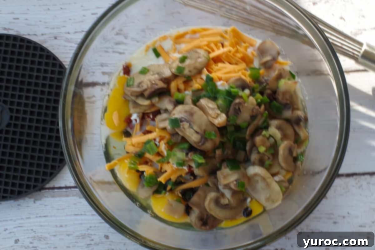 Mediterranean Slim Crustless Quiche 7 mushroom and onions added to other ingredients in large bowl
