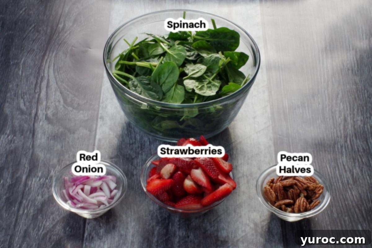ingredients in strawberry spinach pecan salad in glass bowls, labelled