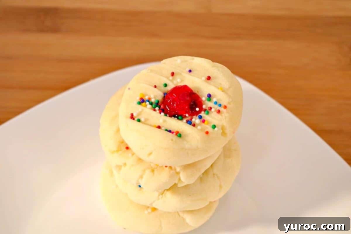 4 whipped shortbread cookies on a white plate