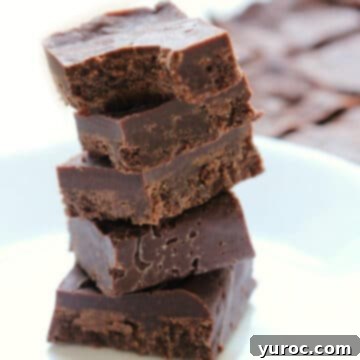 Five pieces of delicious 3-ingredient maple tahini freezer fudge stacked artfully on top of each other.