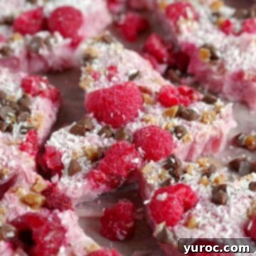 Broken pieces of raspberry bliss frozen yogurt bark on a serving dish.