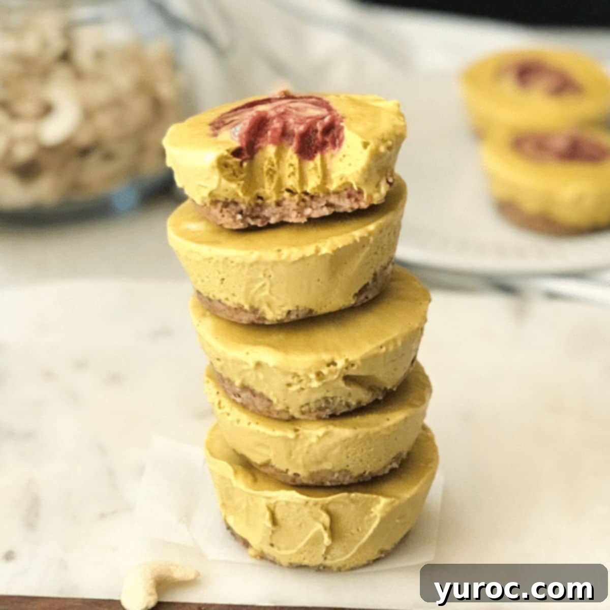 A beautifully presented mini mango cheesecake, adorned with fresh mango slices.