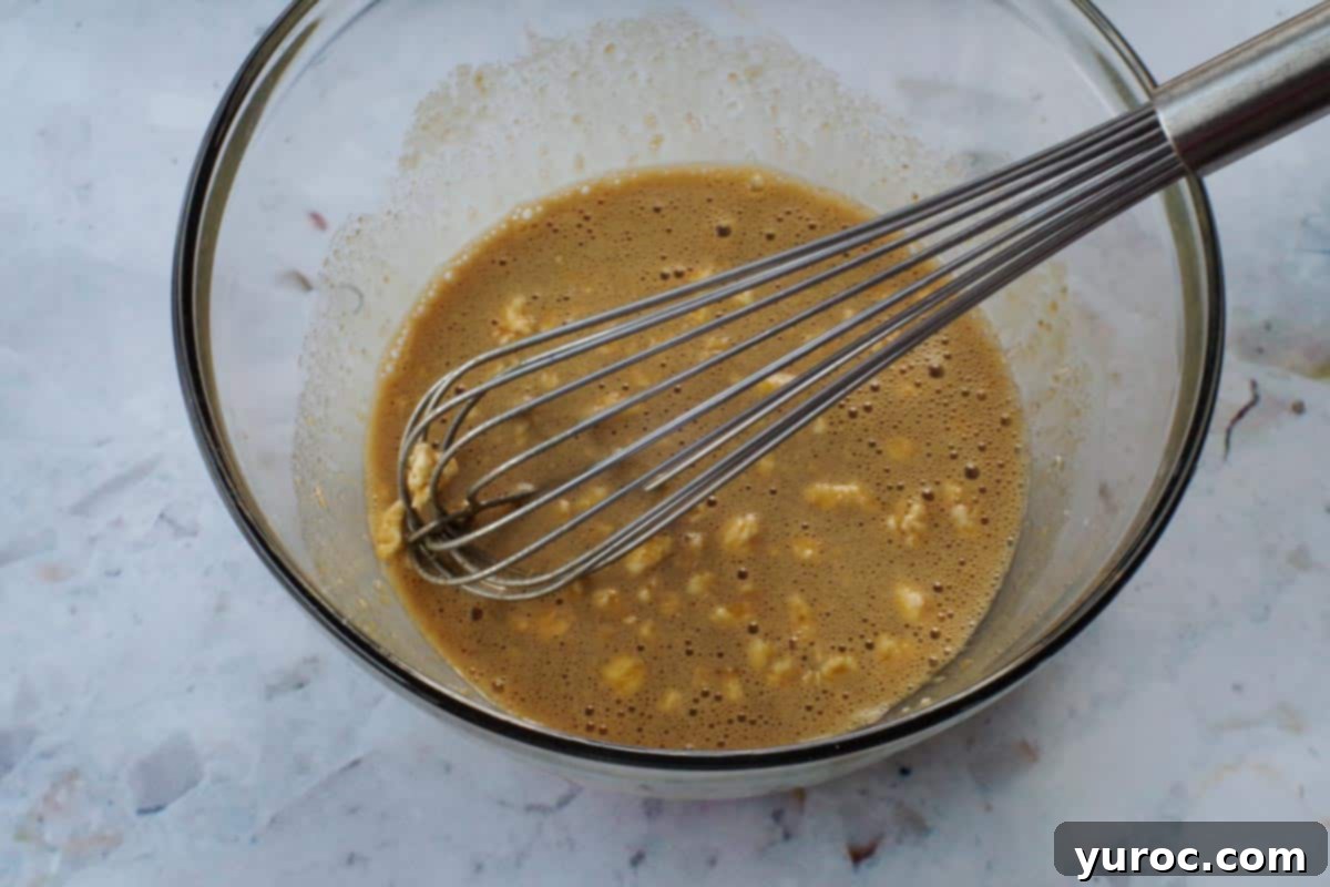 whisk in large glass bowl, with butter tart mixture