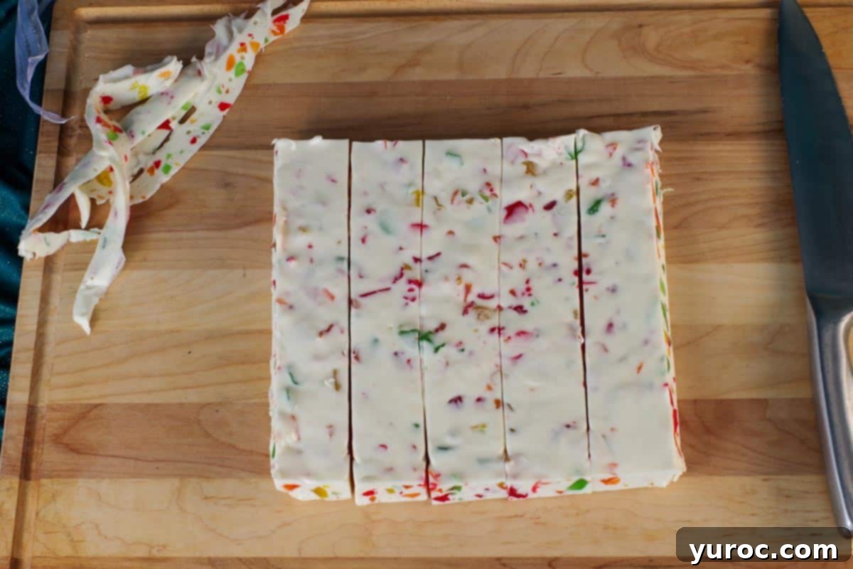 nougat cut into 5 one way on cutting board, with rough edge scraps on the side