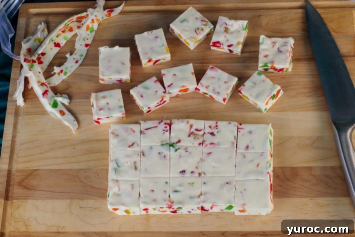 nougat cut into 5 pieces both way, spread on wooden cutting board, with scraps on the side