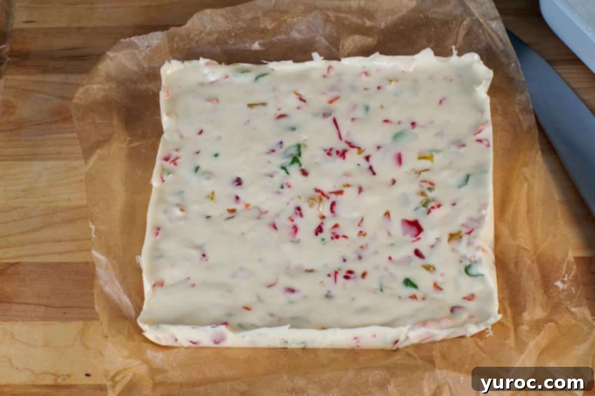 large block of nougat on parchment on wooden cutting board