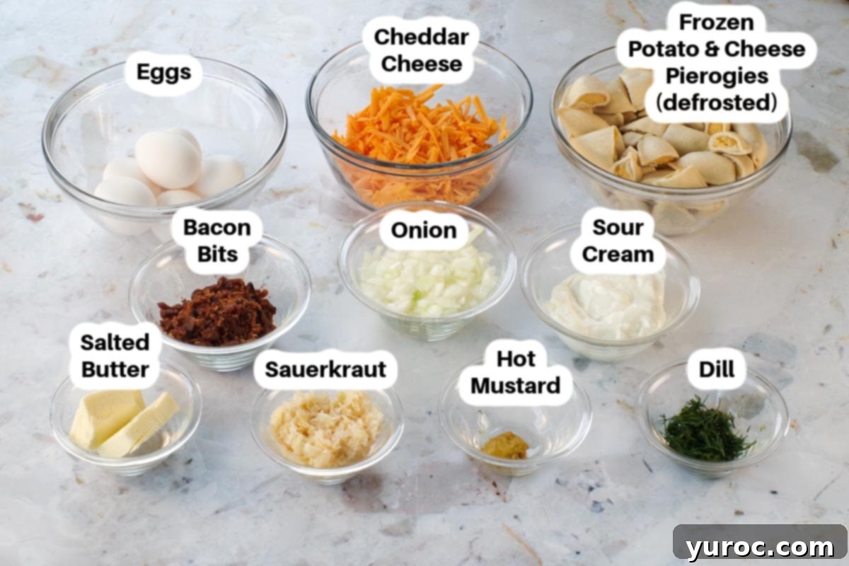 Ingredients in Frozen Pierogi breakfast casserole in small glass bowls, labelled. Including frozen pierogies, butter, chopped onion, bacon bits, sauerkraut, sour cream, cheddar cheese, hot mustard, eggs, and fresh dill.