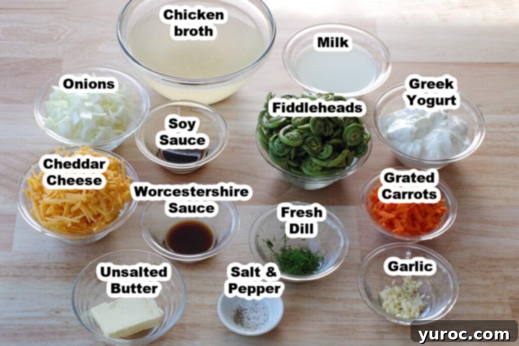 Labeled glass bowls of fiddlehead soup ingredients on a brown wooden surface, including fiddleheads, cheese, dill, and broth.