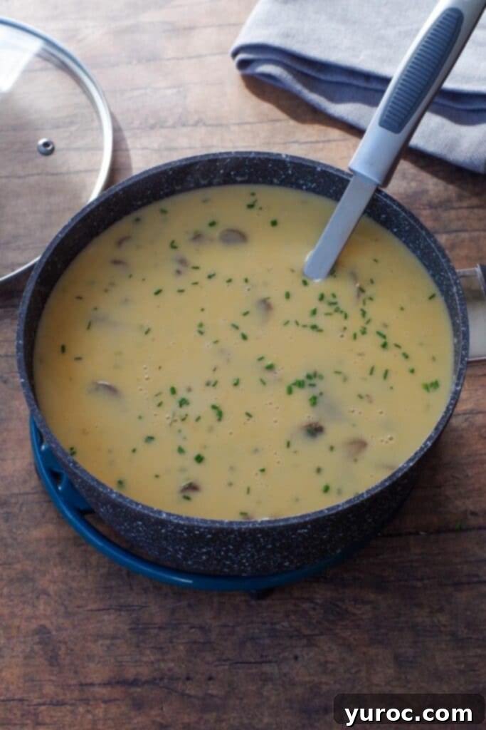 Effortless Beer Cheese Soup 8 A close-up shot of the Beer Cheese Soup, now fully thickened and creamy, showing its smooth texture and readiness to be served. The image emphasizes the desirable consistency of the finished soup.