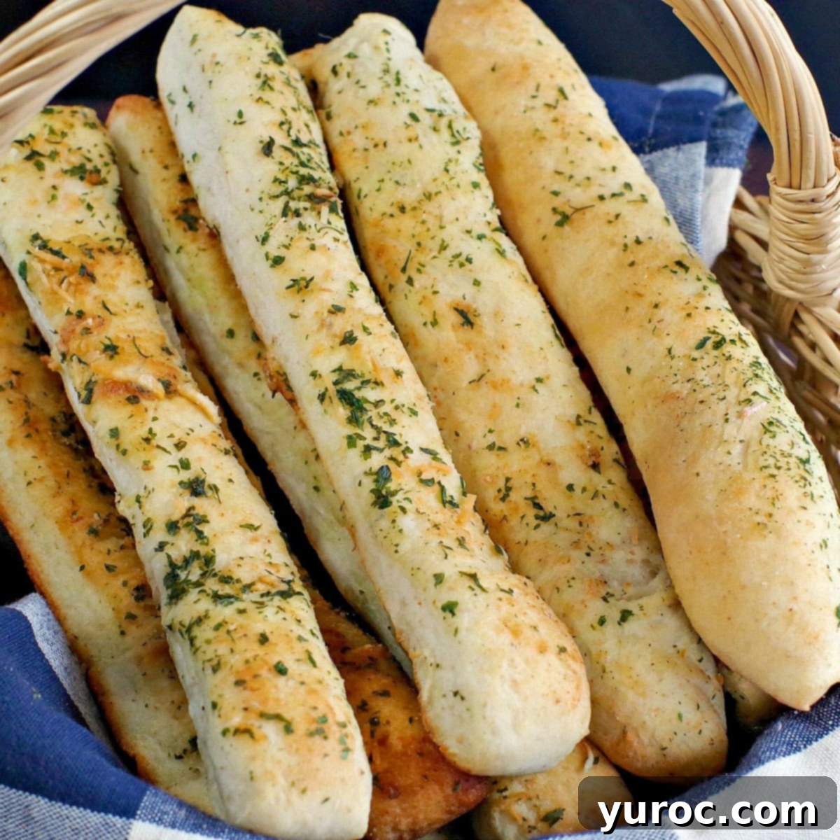 Effortless Beer Cheese Soup 9 A rustic basket filled with golden-brown, freshly baked Italian breadsticks, perfectly complementing a hearty soup or meal. The image evokes warmth and homemade comfort.