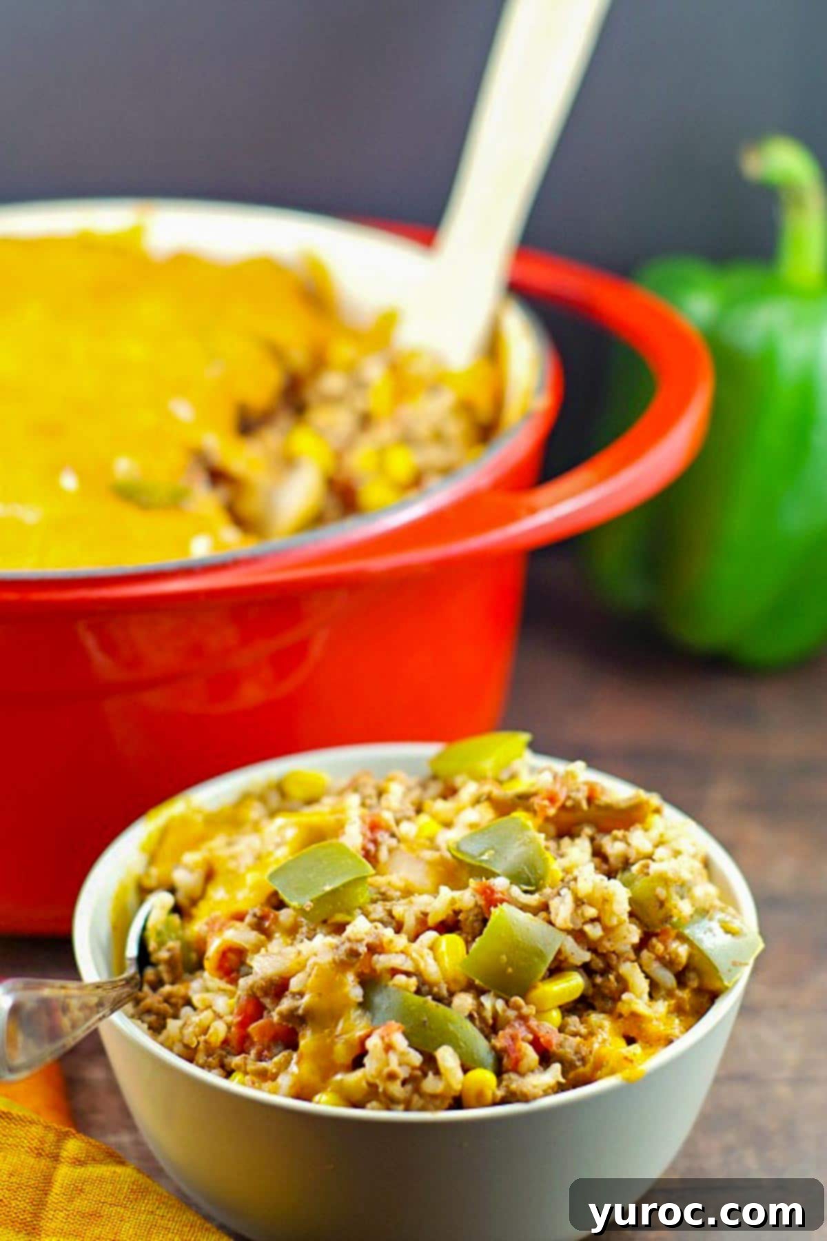 bowl of ww stuffed green pepper casserole in front of a orange casserole dish in background
