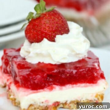 a slice of strawberry pretzel dessert on a white plate