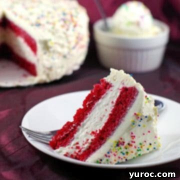 Slice of red velvet ice cream cake with whole cake in the background and a bowl of no churn ice cream