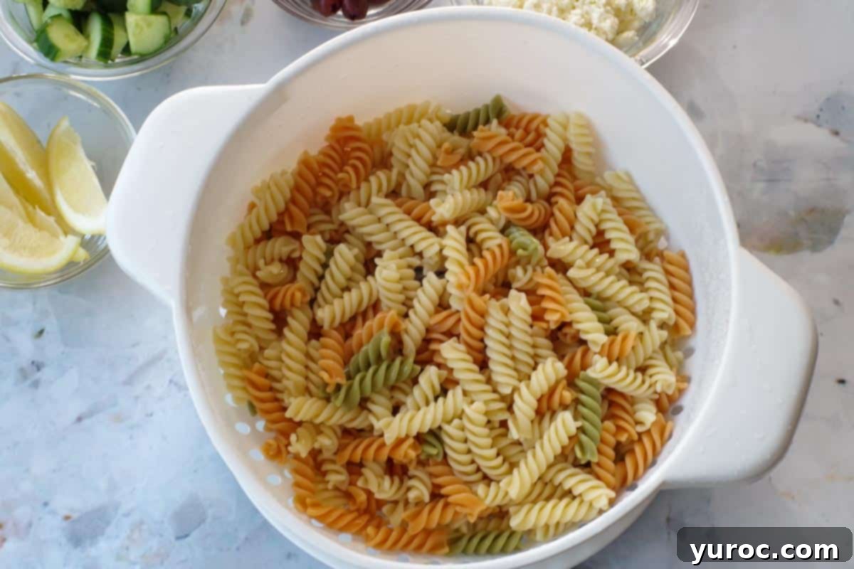 Cooked and drained pasta in a colander.