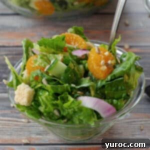 Mandarin Orange salad in a small glass bowl with a fork, highlighting its appeal.