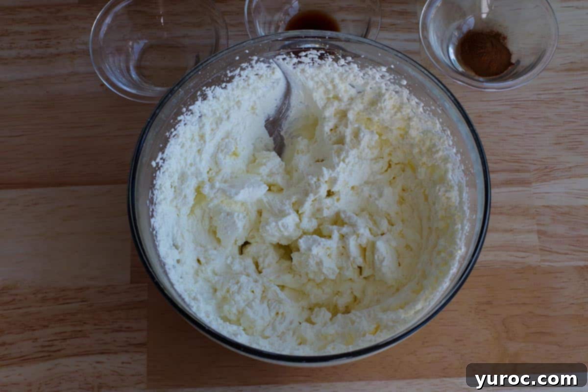 whipped cream beaten to stiff peaks, in a large glass bowl, ready for mixing