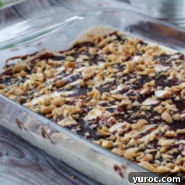 15 Easy No Bake Potluck Desserts 2 Drumstick Dessert in a glass pan on a wooden surface