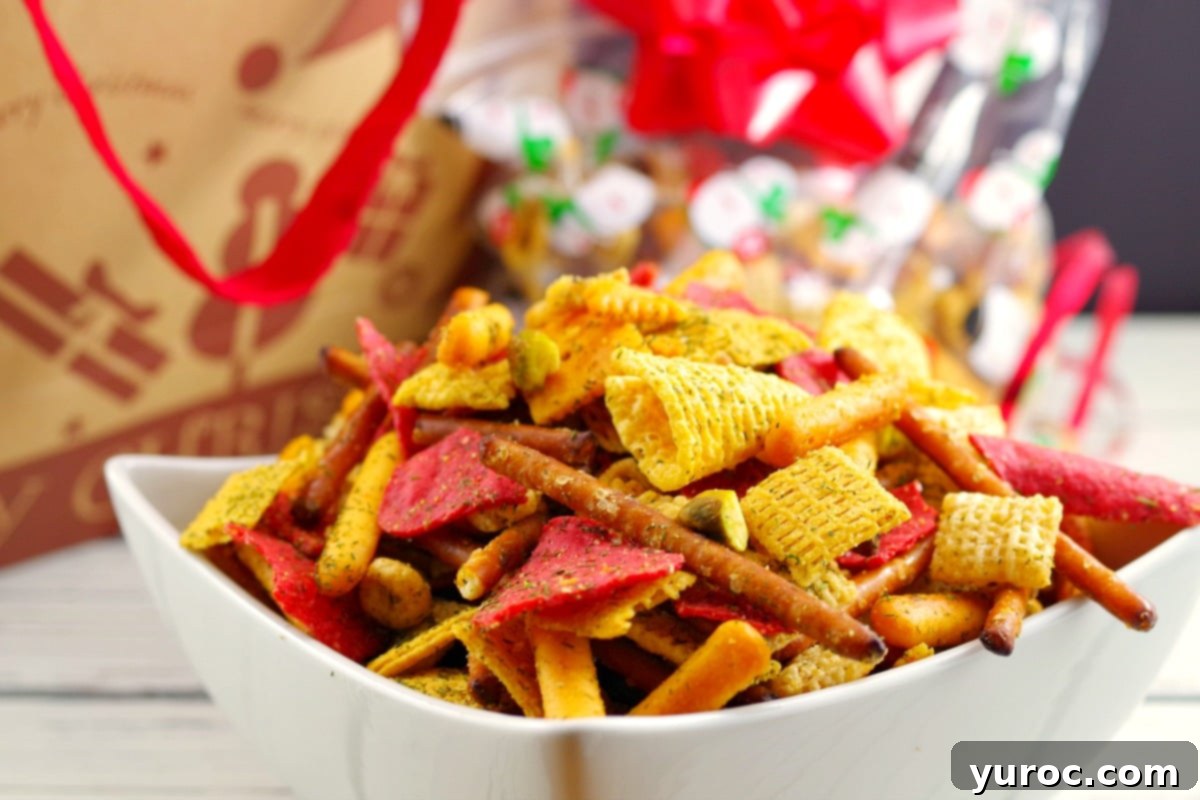 A large bowl of the best Chex Mix recipe, a savory snack mix perfect for holiday gatherings, showcasing its rich, golden-brown color and diverse ingredients.