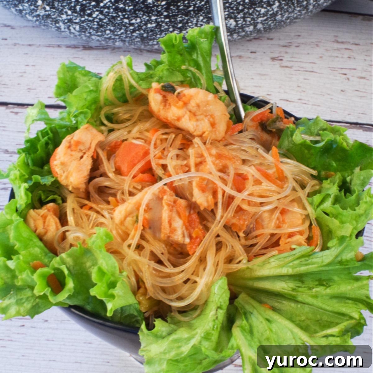 Honey Fire Chicken Lettuce Embrace 11 Spicy chicken lettuce wrap, in salad form, in a bowl with a fork.