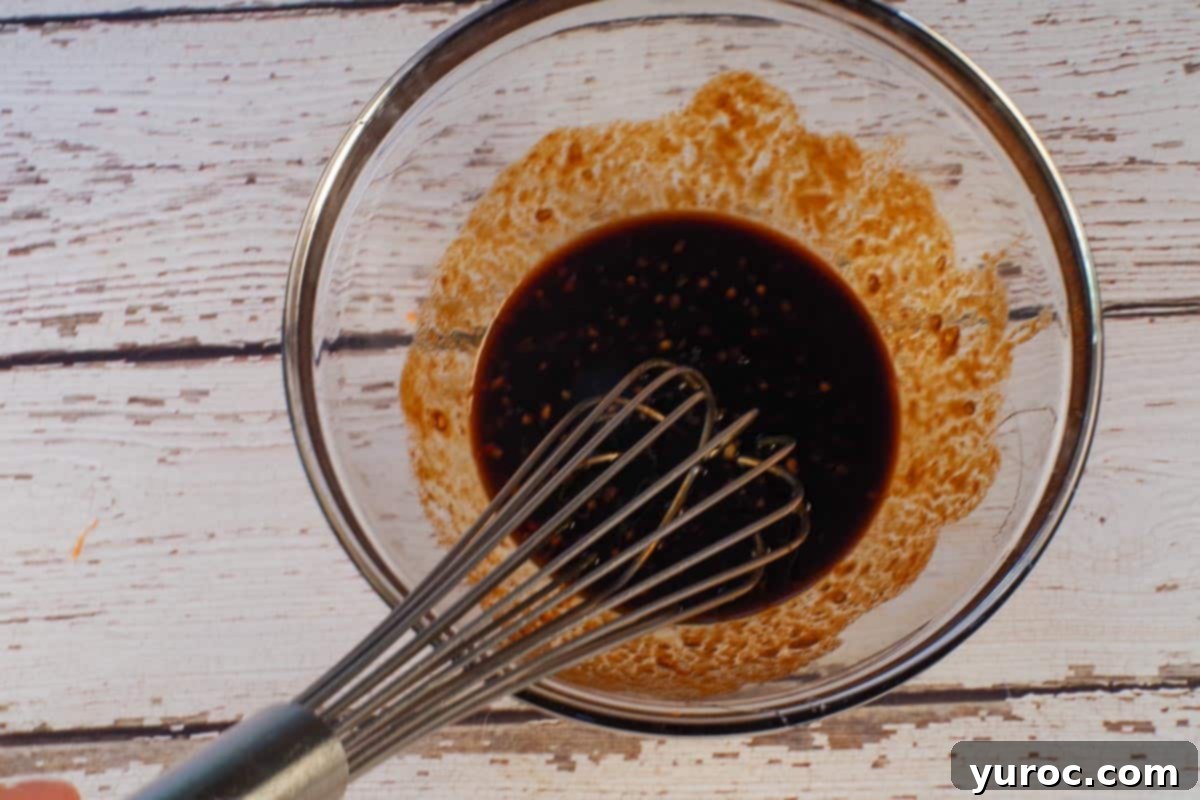 Honey Fire Chicken Lettuce Embrace 5 Garlic, soy sauce, sriracha and honey whisked together in a bowl.