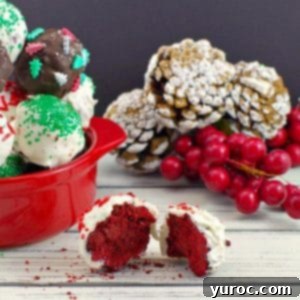 red velvet brownie bite split in half with dish of red velvet brownie bites in the background