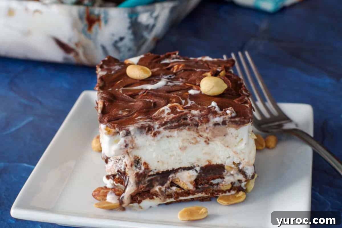 piece of buster bar ice cream cake on white plate with fork and whole glass pan in background