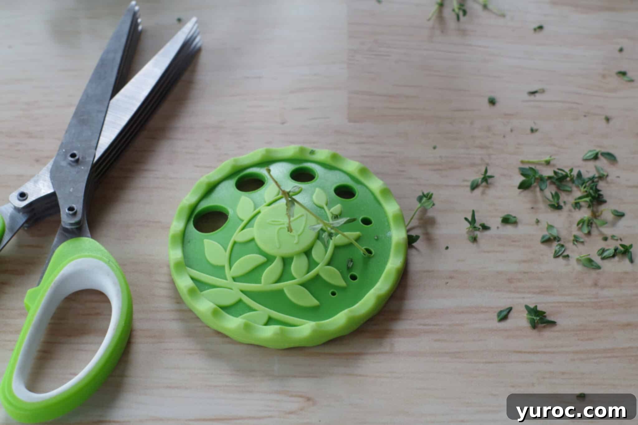 herb trimmer and stripper on beige counter surface with thyme stem and leaves separated