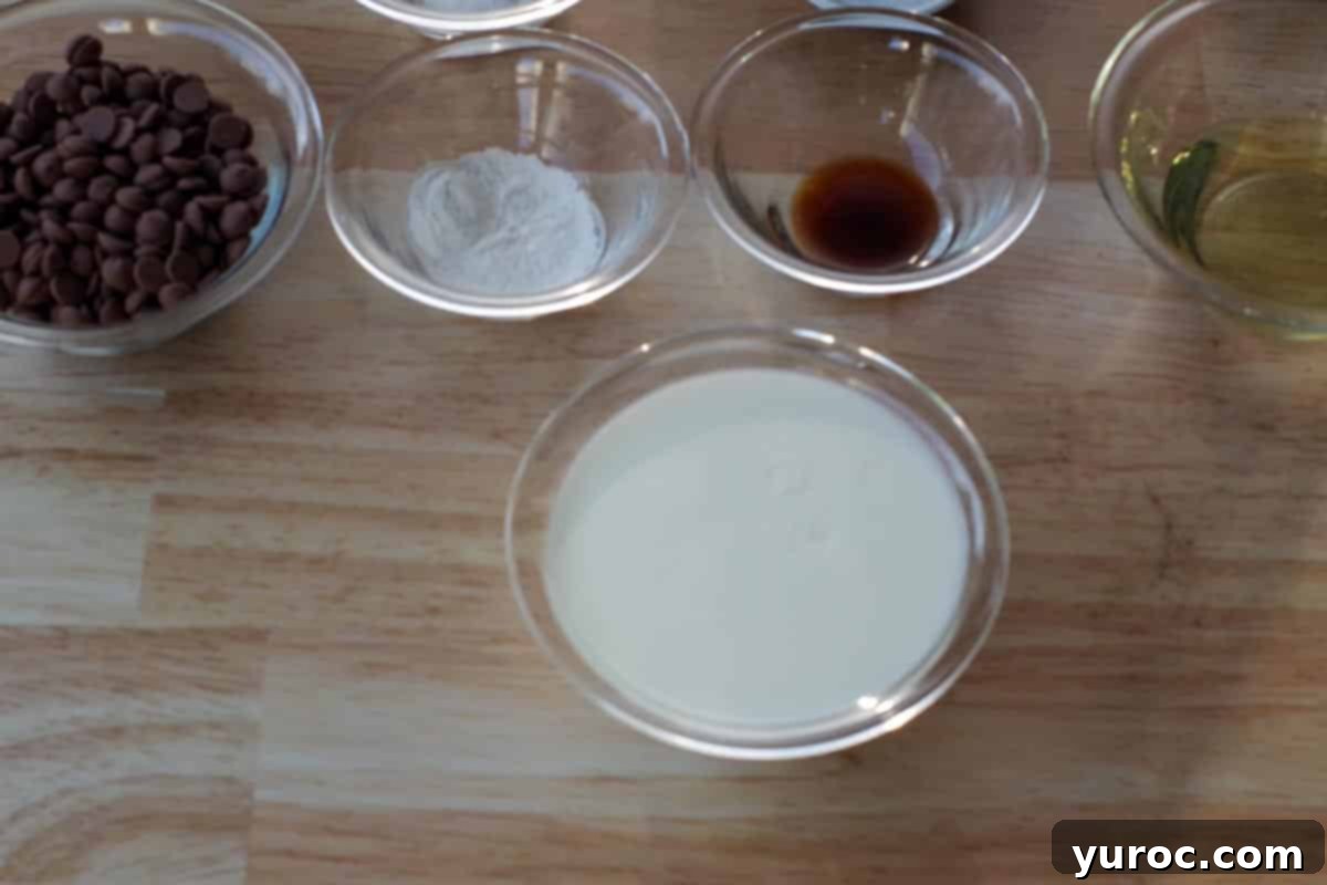 Effortless Sheet Pan Chocolate Chip Pancakes 3 vinegar mixed with milk in a glass bowl with small glass bowls with ingredients in the background