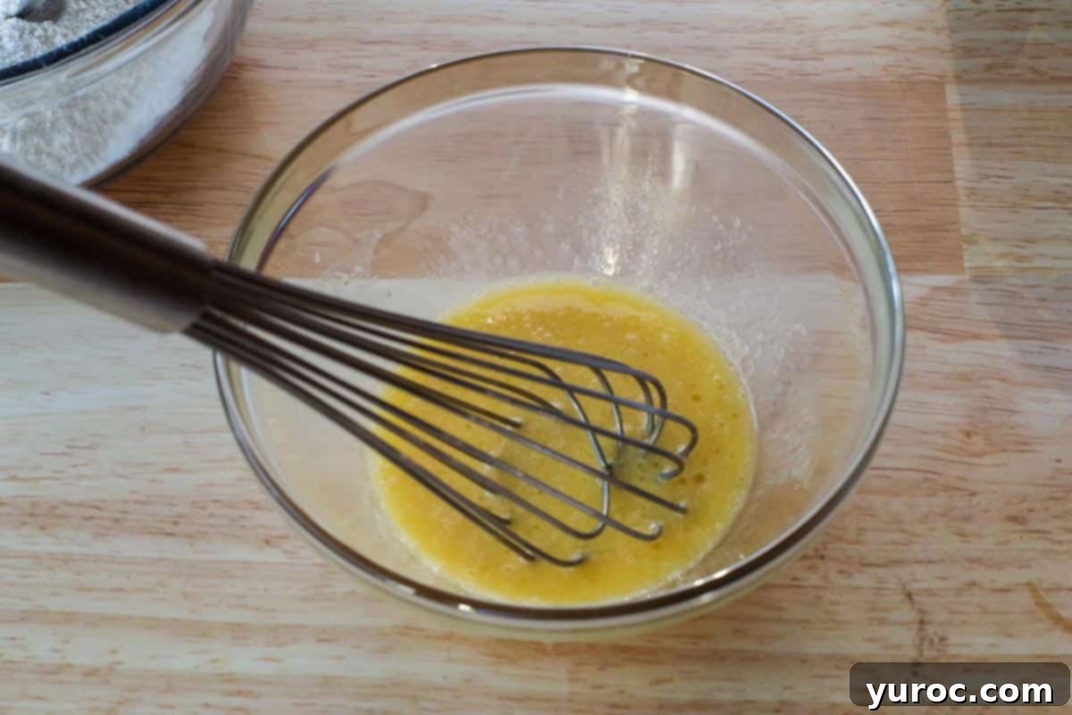 Effortless Sheet Pan Chocolate Chip Pancakes 5 egg, oil and vanilla whisked together in glass bowl