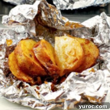 cooked, sliced, onion baked potato on foil