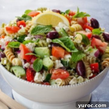 Greek pasta salad in white bowl
