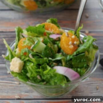 Mandarin Orange salad in a small glass bowl with a fork
