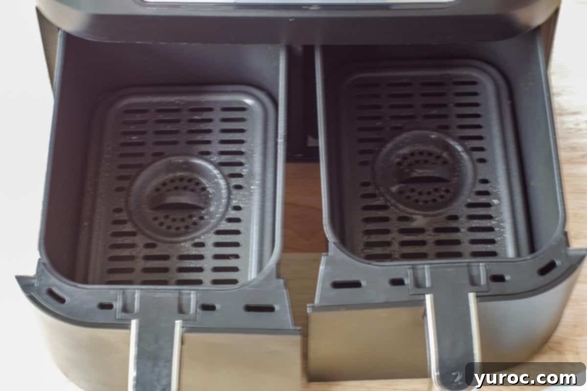 2 air fryer drawers sprayed with oil