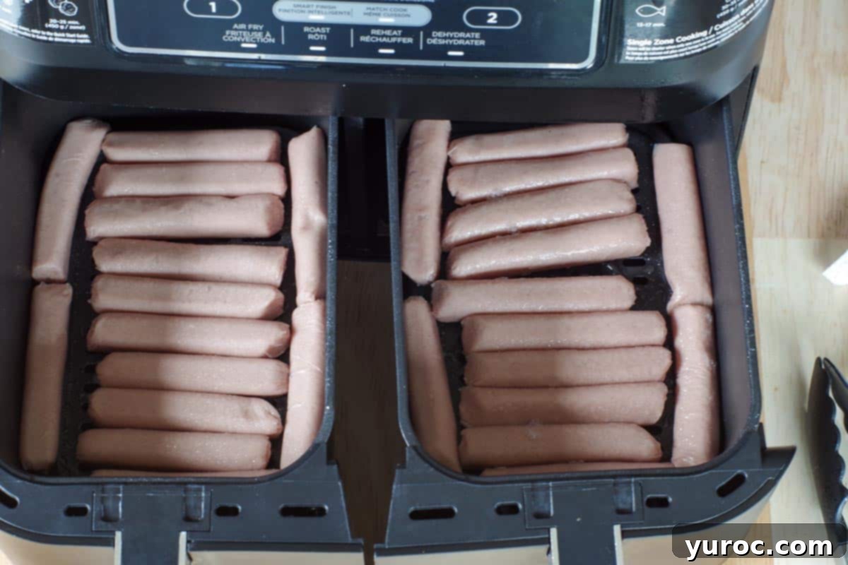 uncooked turkey sausages in single layer in air fryer drawer