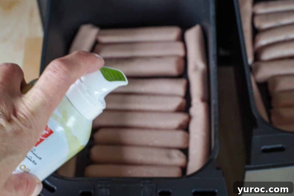 oil being sprayed on turkey sausages