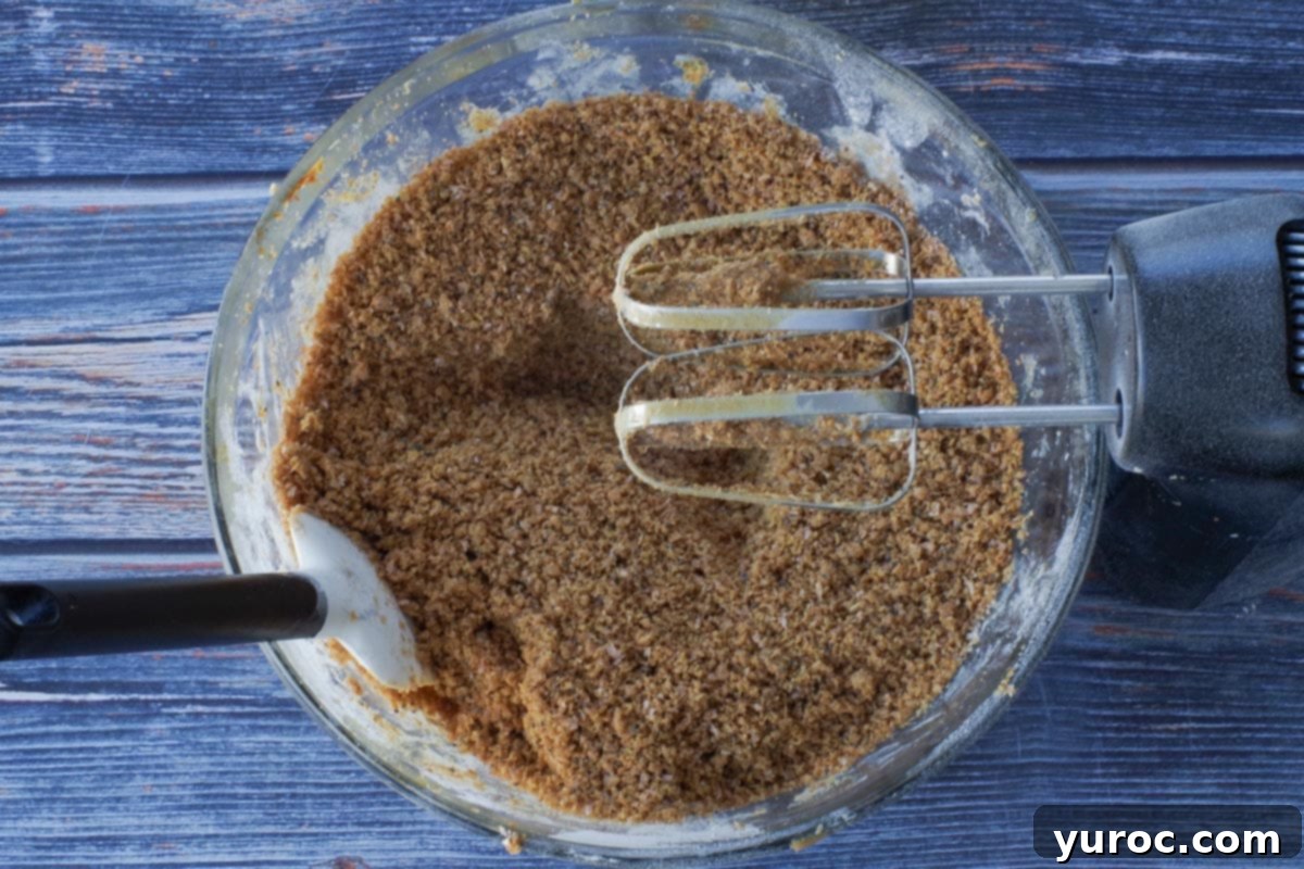 Dry ingredients and wet ingredients beaten together with electric mixer in a large glass bowl.
